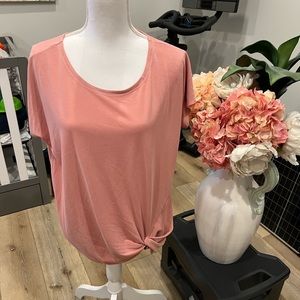 Pink top with Knot In The bottom corner. size L